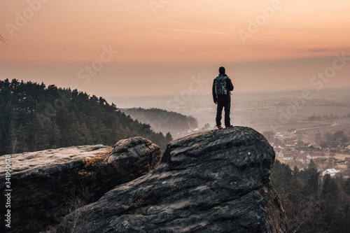 A man looking into the landscape from the top of the rock in Bohemian Paradise (Český ráj).  © Hanikova