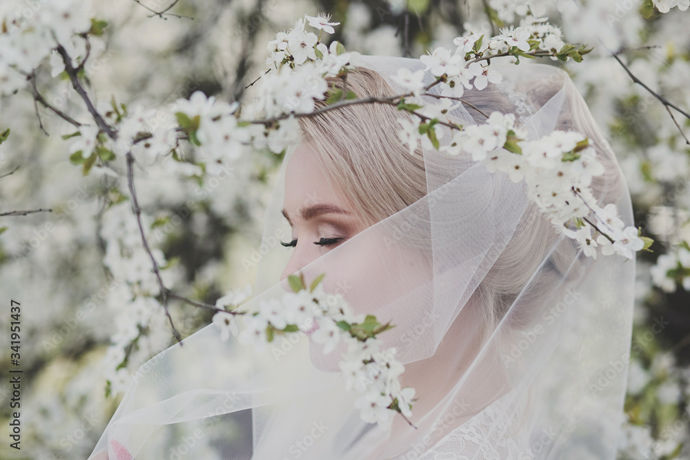 tender portrait of a beautiful blonde bride in a blooming garden. makeup for the bride tender portrait of a beautiful blonde bride in a blooming garden. makeup for the bride