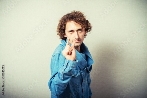Φωτογραφία Young handsome man show a little bit