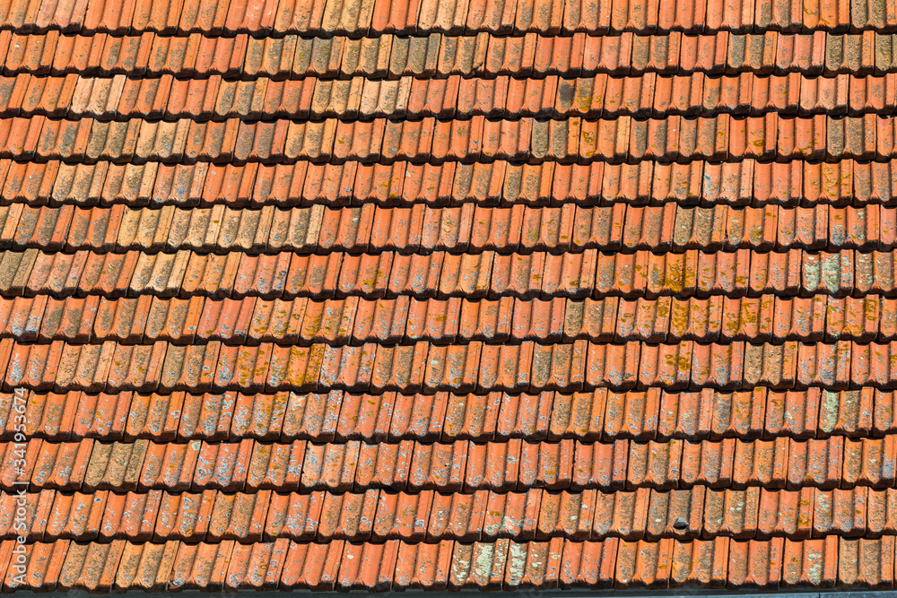 Texture of orange clay roof tiles. Red old dirty roof. Old roof tiles. Construction equipment build a house.