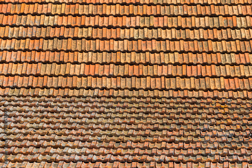 Texture of orange clay roof tiles at different angles. Red old dirty roof. Old roof tiles. Construction equipment build a house. Texture of orange clay roof tiles at different angles. Red old dirty roof. Old roof tiles. Construction equipment build a house.