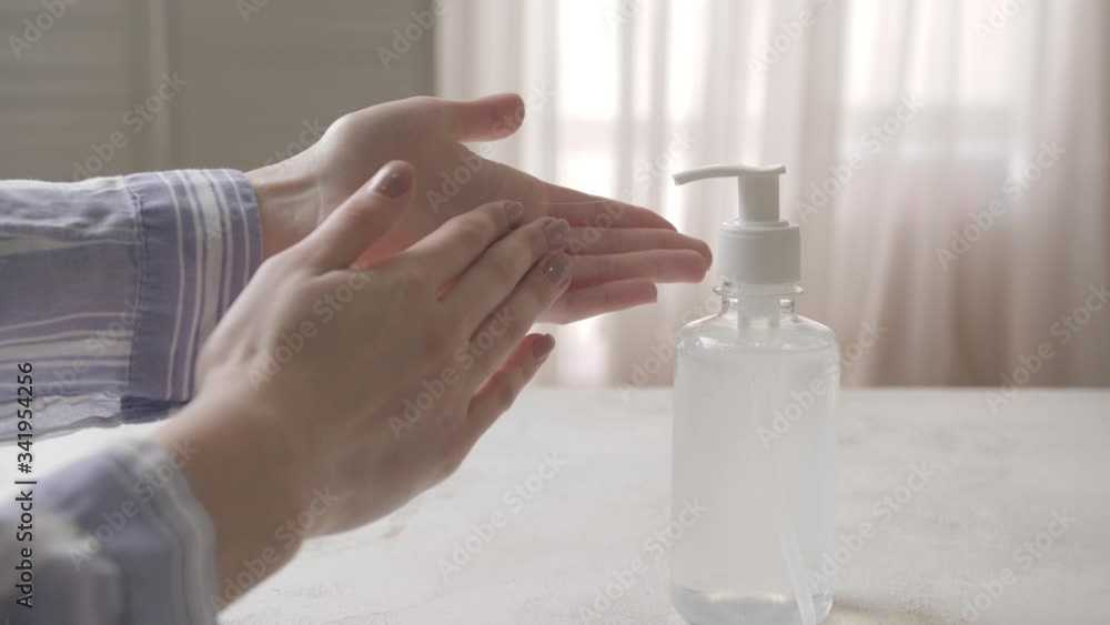 Woman using sanitizer at home Woman using sanitizer at home