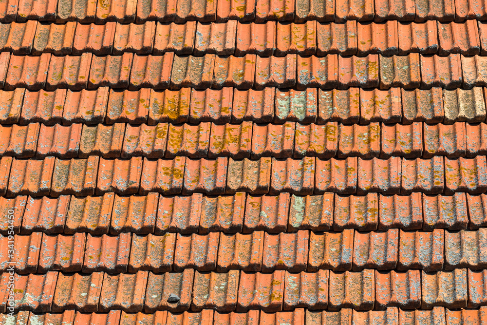 Texture of orange clay roof tiles. Red old dirty roof. Old roof tiles. Construction equipment build a house.