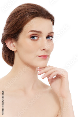 Portrait of young beautiful healthy woman touching her face, copy space