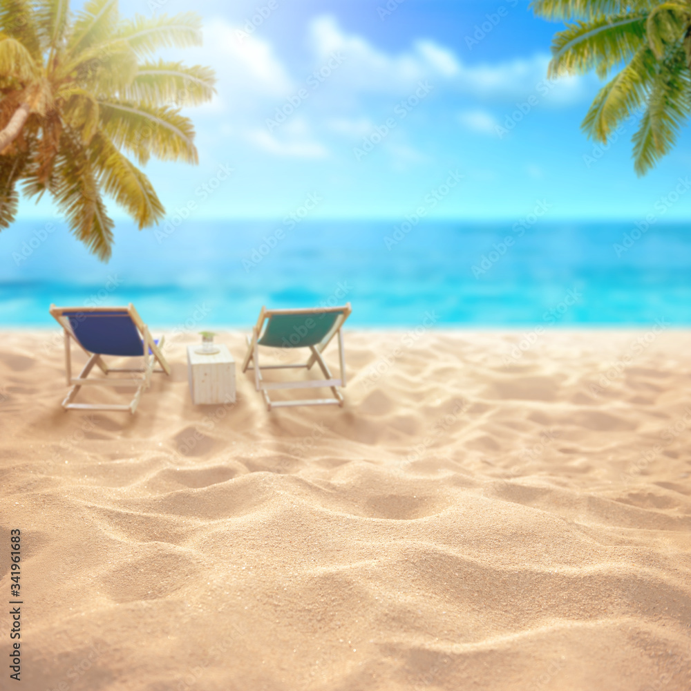 Summer sandy beach with blurred sea background and beach chair and coconut tree  Montage of summer relaxation background