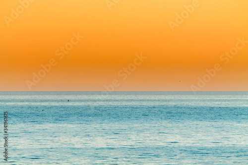orange Sunset over the calm blue ocean