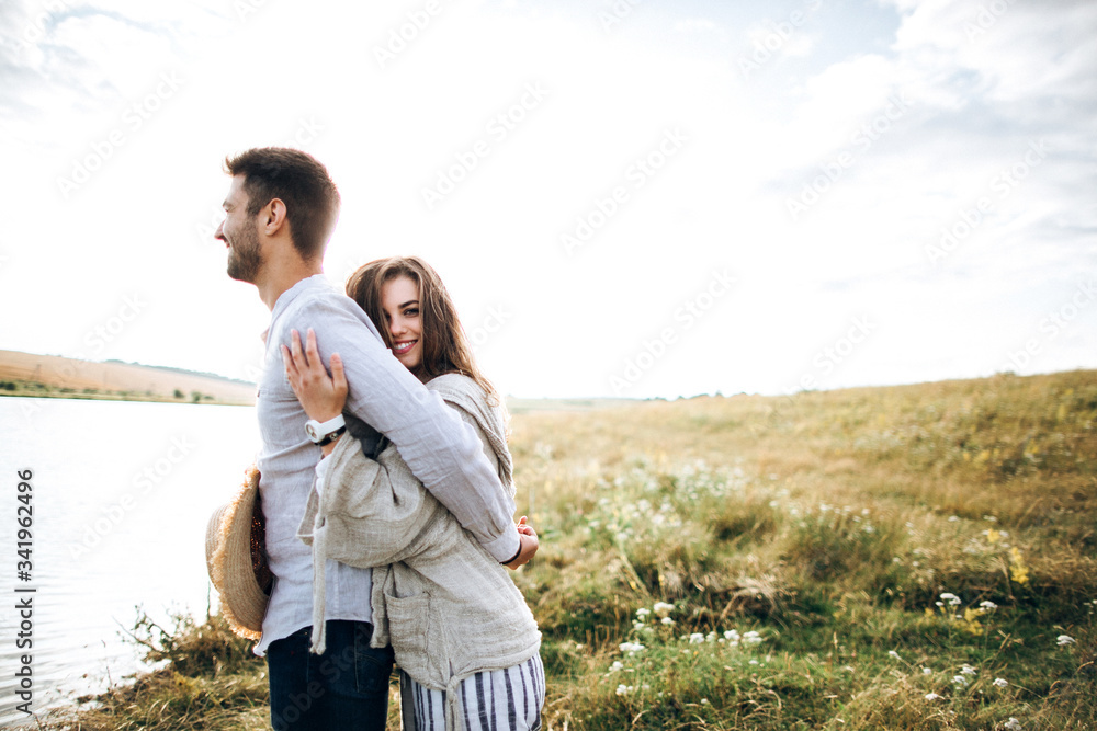 Close up portrait guy and girl hipster travel. Beautiful loving couple having fun, cuddling, smiling on sky background in field. Close up portrait guy and girl hipster travel. Beautiful loving couple having fun, cuddling, smiling on sky background in field.