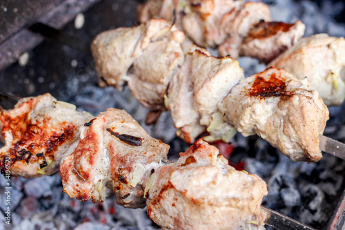 Grilled delicious pork kebab, shashlik or kebab, skewer, on the grill closeup