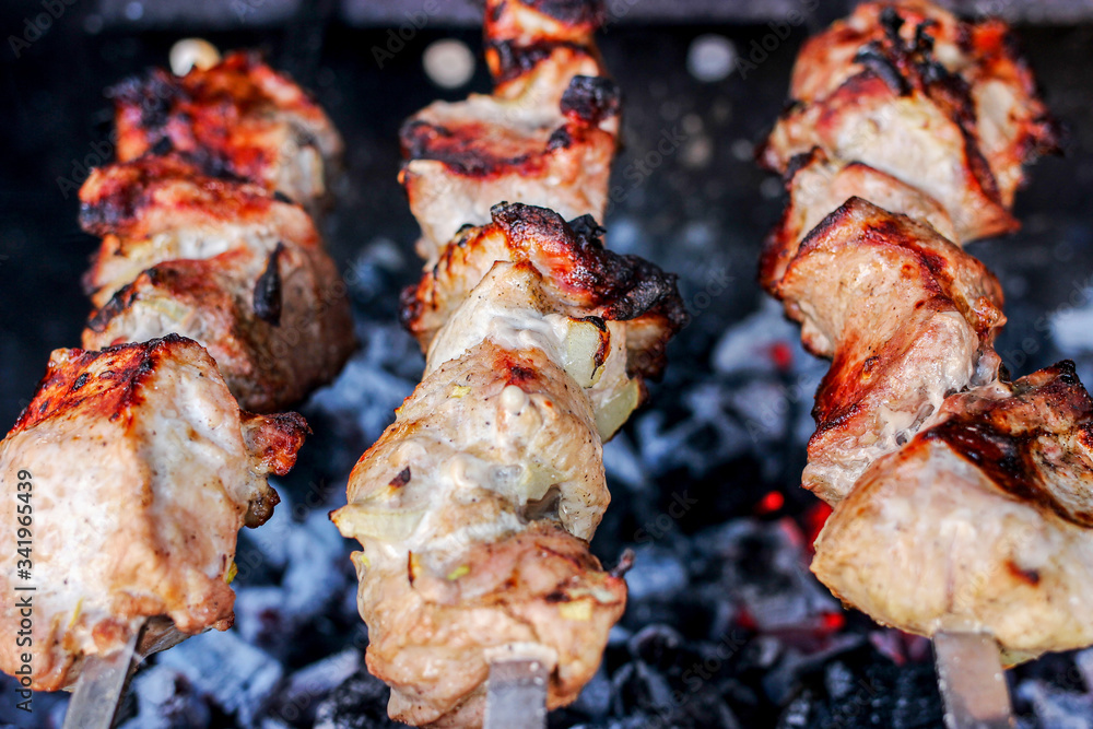 Grilled delicious pork kebab, shashlik or kebab, skewer, on the grill closeup