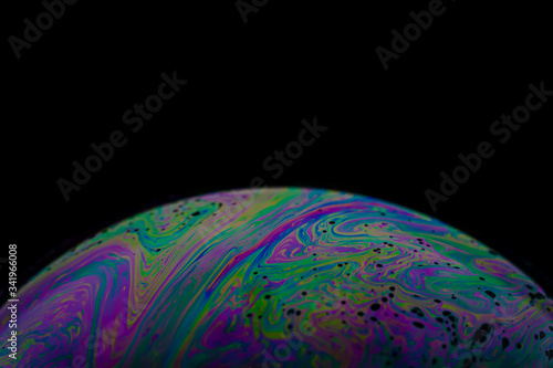 Soap bubble close up macro photography with colorful swirly pattern of light spectrum