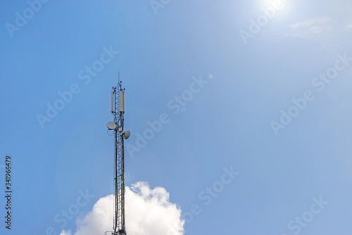 Cell phone, TV, Internet tower rise against a blue sky