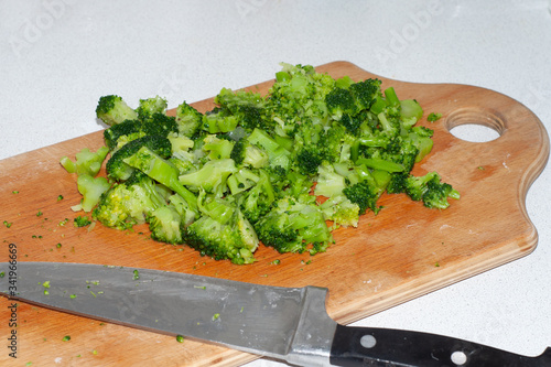 Sliced with a knife broccoli. On a wooden board