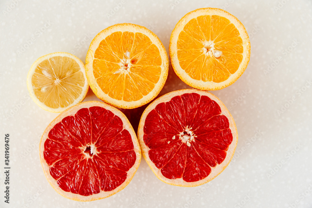 Half of grapefruit, orange, lemon cut for fresh juice. Color splash. Tropical fruits Half of grapefruit, orange, lemon cut for fresh juice. Color splash. Tropical fruits