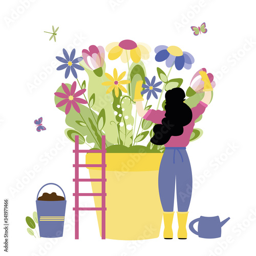 Trendy spring, gardening people concept. Stylish girl with fashionable hairstyle cares for spring flowers