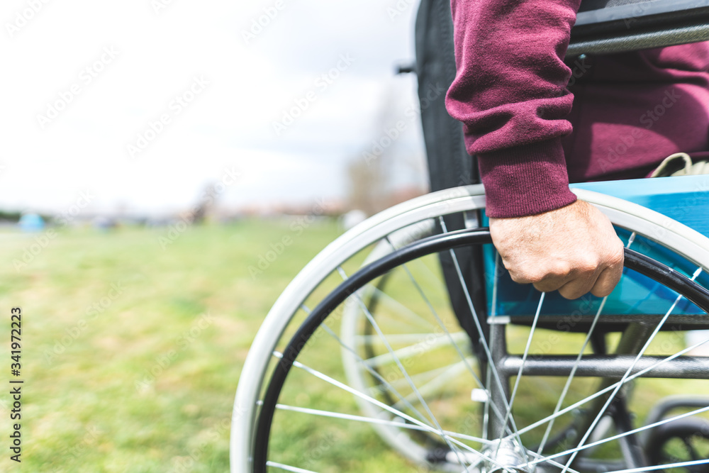 Naklejka premium Close Up of Man on Wheelchair Outdoors.