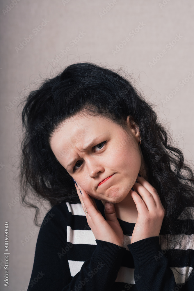 Woman sad, offended. Gray background Woman sad, offended. Gray background