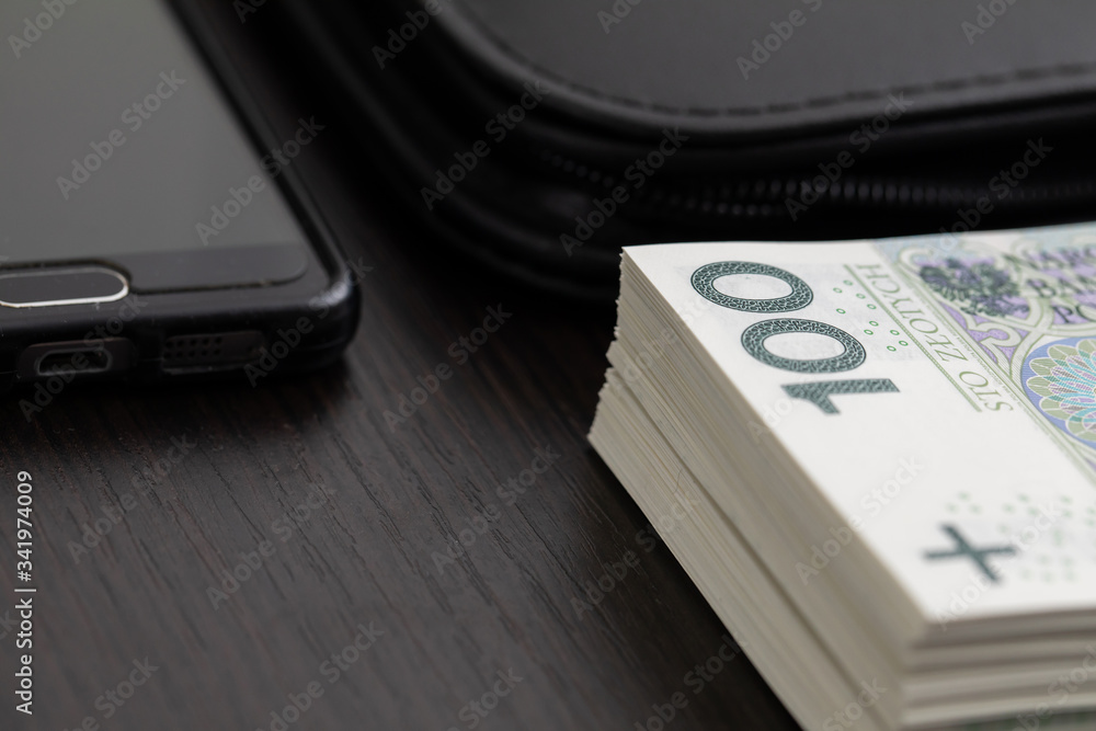 Polish paper banknotes with a face value of PLN 100 are the official currency of the country and are on the table. Polish paper banknotes with a face value of PLN 100 are the official currency of the country and are on the table.