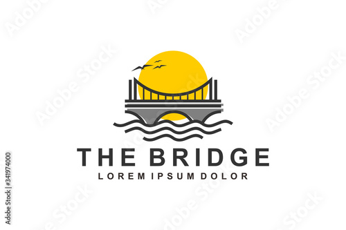 Suspension bridge logo over river with sunset view