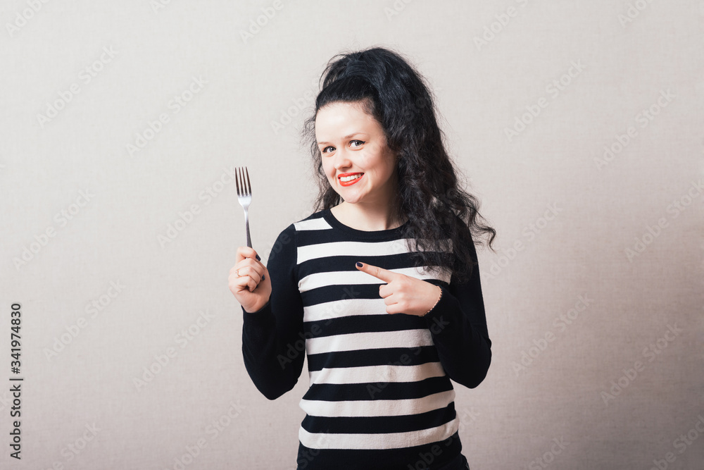 Woman with a fork. Gray background. Woman with a fork. Gray background.