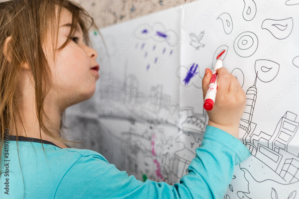 Cute little girl coloring on her wall at home. Cute little girl coloring on her wall at home.