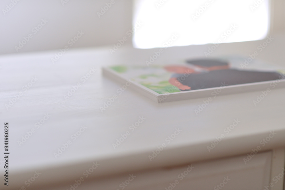 Photographs on a white work table with bokeh. Photographs on a white work table with bokeh.