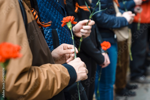 Victory Day. Red carnation in hands