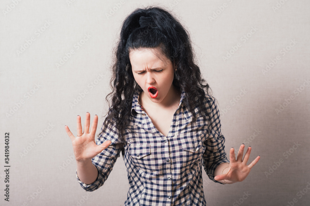 Closeup portrait of young annoyed woman with bad attitude, giving talk to hand gesture with palm outward. Negative human emotion, facial expression feeling, body language Closeup portrait of young annoyed woman with bad attitude, giving talk to hand gesture with palm outward. Negative human emotion, facial expression feeling, body language