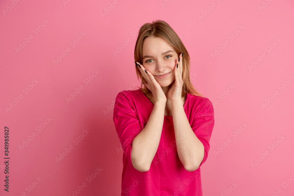 Smiling cute, happy. Caucasian young woman's portrait isolated on pink studio background, monochrome. Beautiful female model. Concept of human emotions, facial expression, sales, ad, trendy. Smiling cute, happy. Caucasian young woman's portrait isolated on pink studio background, monochrome. Beautiful female model. Concept of human emotions, facial expression, sales, ad, trendy.