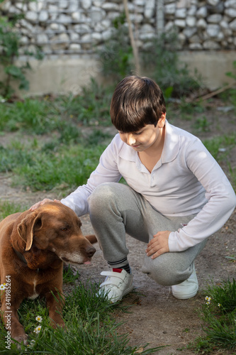 A child plays with a dog
