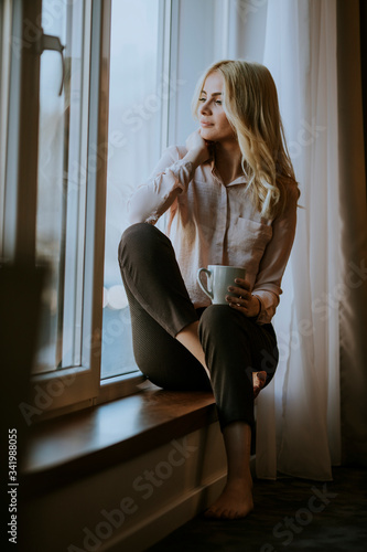 Young woman with cup of tea...