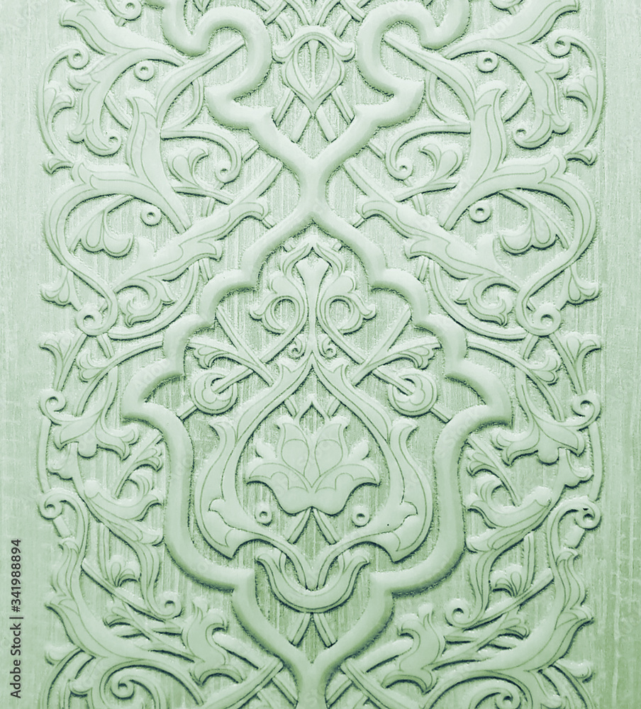 Green ceramic tile with floral pattern for wall and floor decoration. Concrete stone surface background. Texture with ornament  for interior design project.