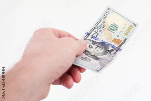 banknote 100 dollars held in hand