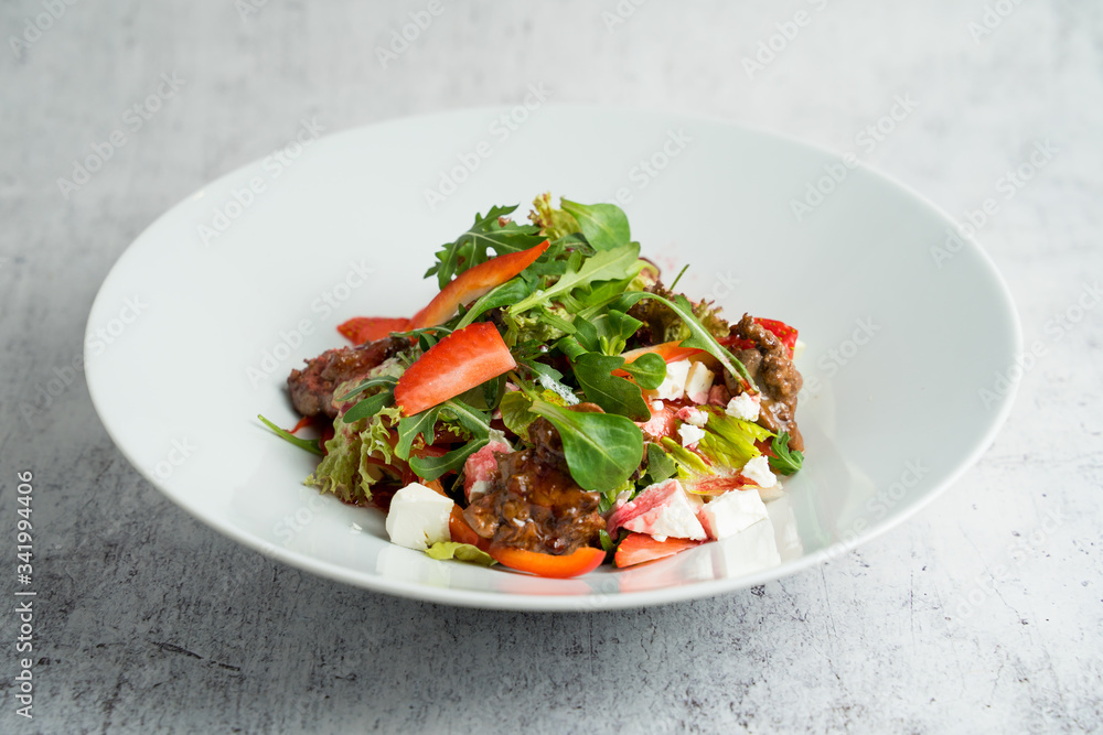 Salad with warm chicken liver, fresh strawberries and vegetables Salad with warm chicken liver, fresh strawberries and vegetables