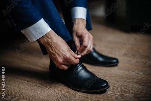A stylish man wears classic shoes close-up. Fashion