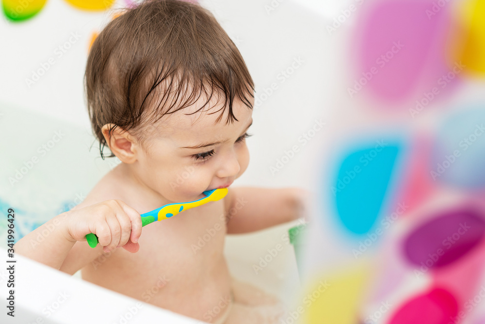 A one-year-old baby washes in the bathtub, plays with toys, learns to brush his teeth. A one-year-old baby washes in the bathtub, plays with toys, learns to brush his teeth.