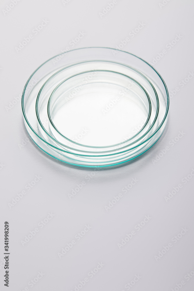 High angle view of laboratory empty glassware on grey background High angle view of laboratory empty glassware on grey background