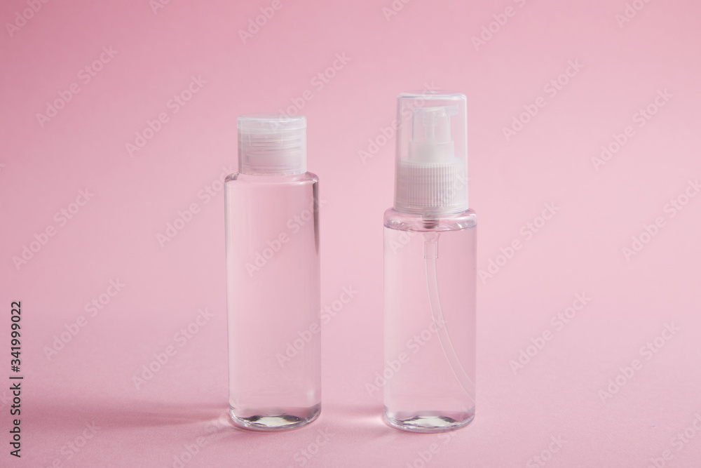 Sanitizer spray and lotion bottle on pink background Sanitizer spray and lotion bottle on pink background