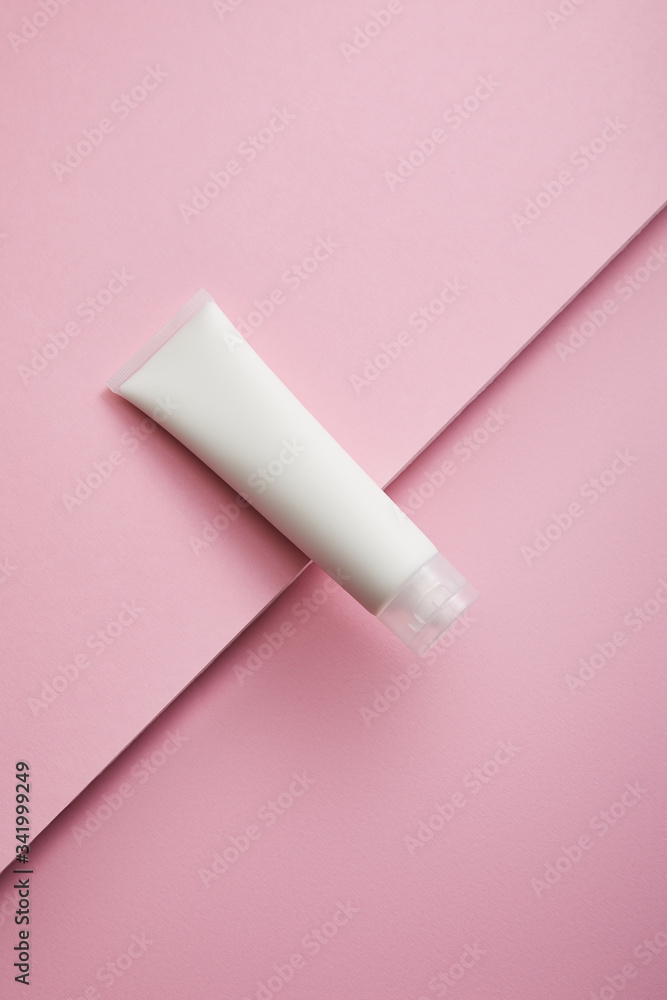Top view of cosmetic cream tube on pink background Top view of cosmetic cream tube on pink background