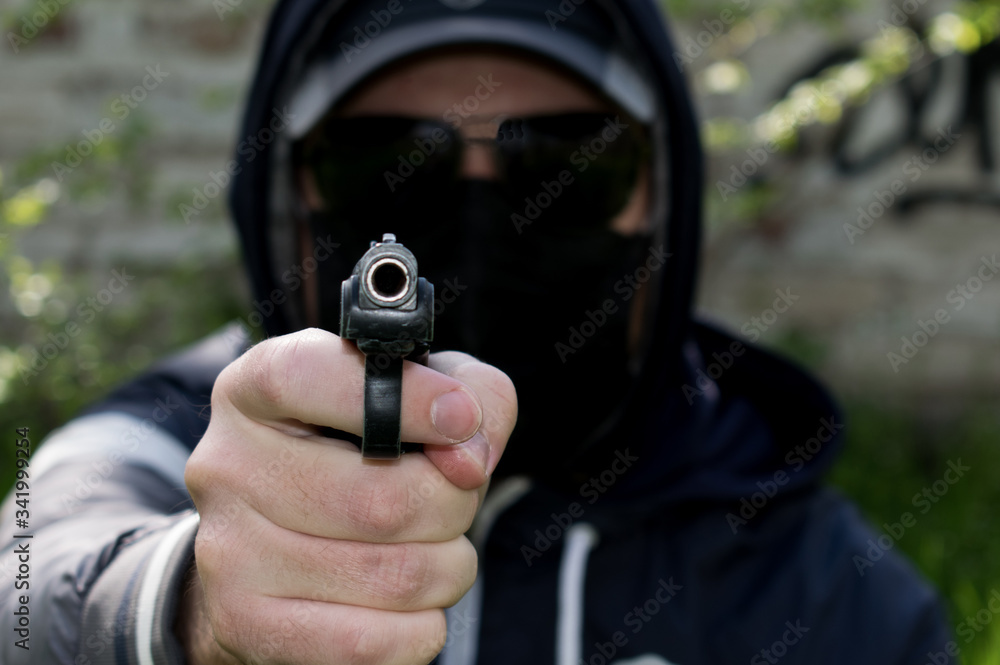 Man in a black mask with a gun Man in a black mask with a gun