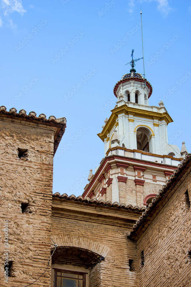 roof of old spanish church with cross, background with historical building	