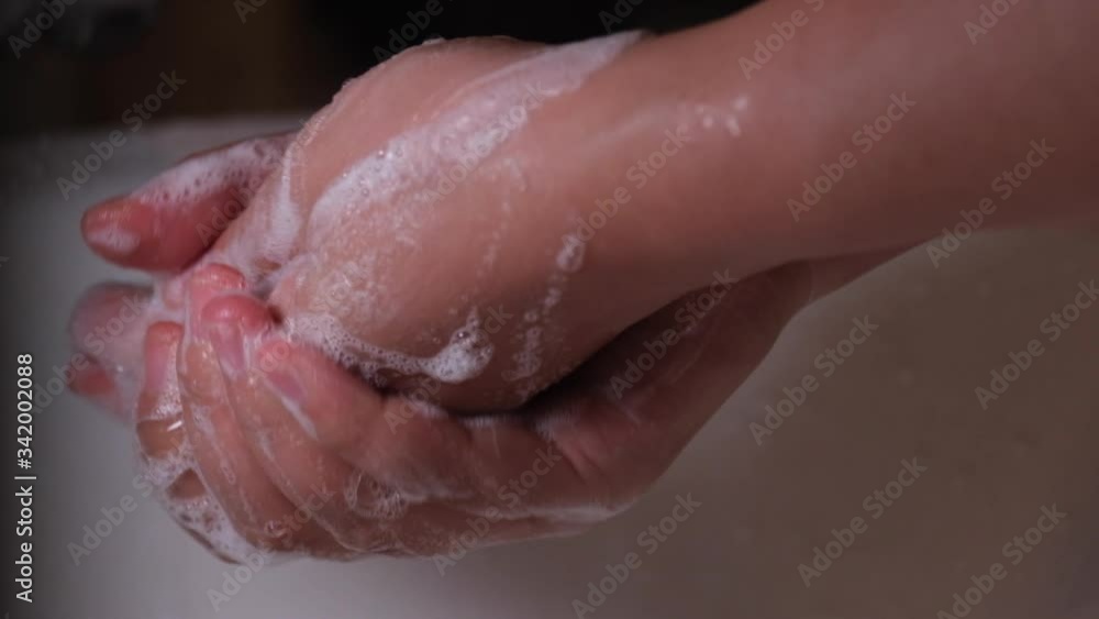 Close up of asian wonan washing hands with soap for protection of coronavirus, slow motion