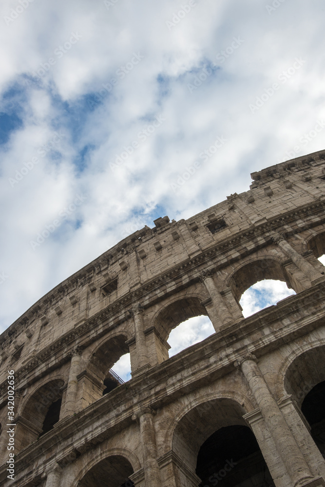 Colosseum in Rome, Italy. Ancient Roman Colosseum is one of the main tourist attractions in Europe. People visit the famous Colosseum in Roma center. Scenic view of Colosseum ruins.