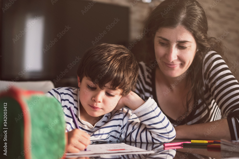 Mother and son doing homework at home Mother and son doing homework at home