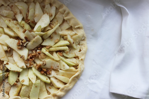 Raw Apple pie before putting it in the oven. Homemade cake. Housework.