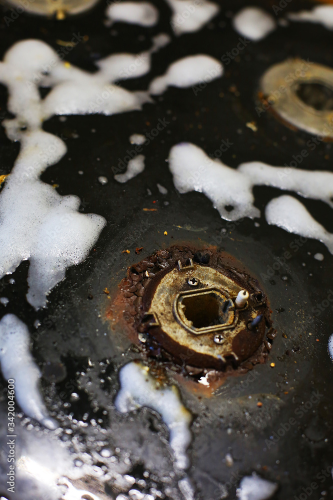 Old dirty gas stove/oven with ugly sticky residue on black glass