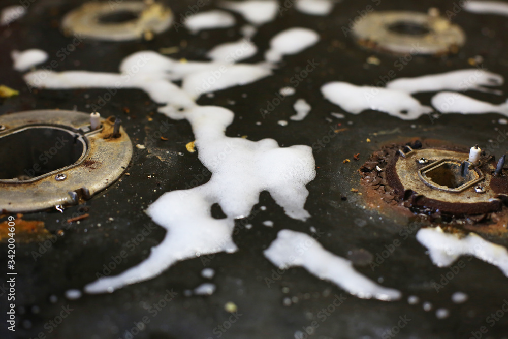 Old dirty gas stove/oven with ugly sticky residue on black glass