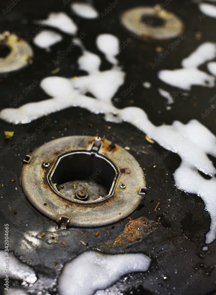 Old dirty gas stove/oven with ugly sticky residue on black glass