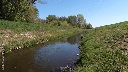 Foto View of artificial water channel connecting dead river channel with river, spring daylight sunshine