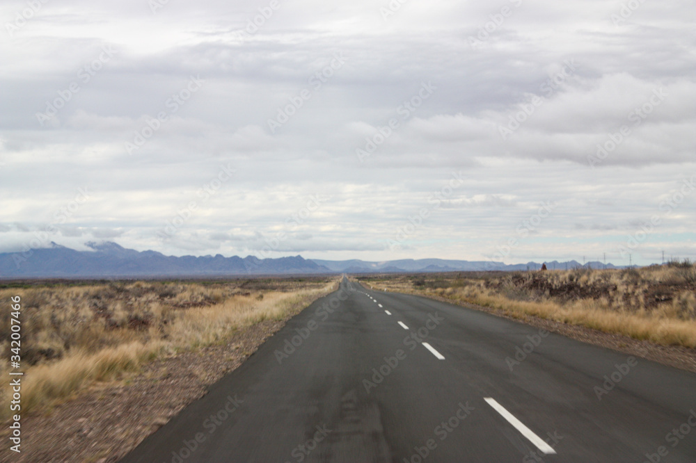 Flat straight road to the mountains Flat straight road to the mountains
