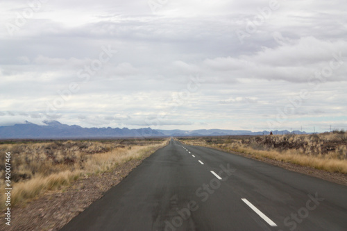 Flat straight road to the mountains